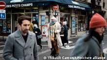 A man wearing a mask to prevent the spread of the COVID-19, rides a one wheel electric, in Paris, Thursday, Dec. 2, 2021. The coronavirus's omicron variant kept a jittery world off-kilter Wednesday, as reports of infections linked to the mutant strain cropped up in more parts of the globe, and one official said that the wait for more information on its dangers felt like an eternity. (AP Photo/Thibault Camus)