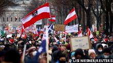 Demonstrators hold flags and placards as they march to protest against the coronavirus disease (COVID-19) restrictions and the mandatory vaccination in Vienna, Austria, December 4, 2021. REUTERS/Lisi Niesner