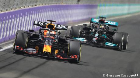 Max Verstappen and Lewis Hamilton compete on the track