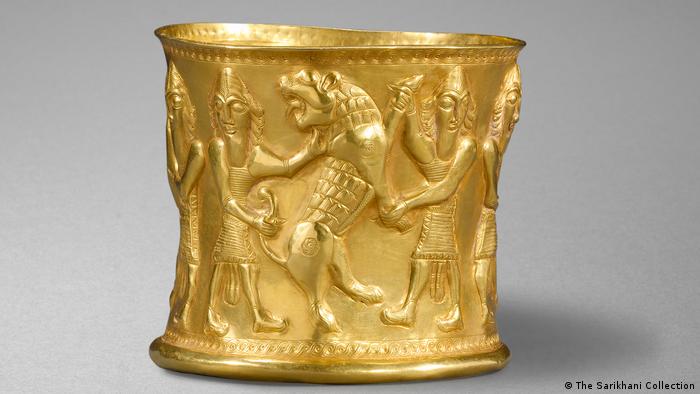 A ancient golden vessel with depictions of animal-people