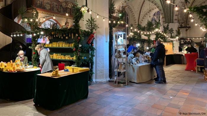 Christmas stands selling colorful wares in an old building