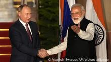 Russian President Vladimir Putin, left and Indian Prime Minister Narendra Modi greet each other before their meeting in New Delhi, India, Monday, Dec.6, 2021. Indian Prime Minister Narendra Modi is meeting Russian President Vladimir Putin on Monday to discuss defense and trade relations as India attempts to balance its ties with the United States. (AP Photo/Manish Swarup)