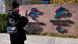 A visitor walks past the logos for the Beijing Winter Olympics and Paralympics in Beijing A visitor walks past the logos for the Beijing Winter Olympics and Paralympics in Beijing