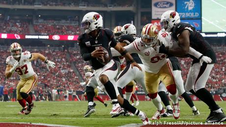Arizona Cardinals quarterback Kyler Murry eludes a San Francisco 49ers defensive end