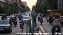 Motorcyclists wearing protective face masks drive along an avenue in downtown Tehran in a heavy traffic on May 30, 2021. Iranians will vote to elect the new President on June 18 amid the new corona virus outbreak in Iran. (Photo by Morteza Nikoubazl/NurPhoto)