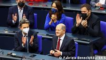 Designated German Chancellor Olaf Scholz receives applause during a session of the German lower house of parliament Bundestag to elect a new chancellor, in Berlin, Germany, December 8, 2021. REUTERS/Fabrizio Bensch