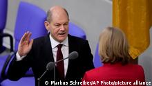 New elected German Chancellor Olaf Scholz is sworn in by parliament President Baerbel Bas in the German Parliament Bundestag in Berlin, Wednesday, Dec. 8, 2021. The election and swearing-in of the new Chancellor and the swearing-in of the federal ministers of the new federal government takes place in the Bundestag on Wednesday. (Photo/Markus Schreiber)