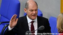 08.12.2021
German Chancellor Olaf Scholz takes the oath from President of the Bundestag (lower house of parliament) Baerbel Bas during a session at the Bundestag (lower house of parliament) in Berlin on December 8, 2021 to swear in the country's next Chancellor. - Members of the parliament elected Olaf Scholz, ushering in a new political era with the centre-left in charge. Together with the Greens and the liberal Free Democrats, Scholz's SPD managed in a far shorter time than expected to forge a coalition that aspires to make Germany greener and fairer. - ALTERNATIVE CROP (Photo by John MACDOUGALL / AFP) / ALTERNATIVE CROP (Photo by JOHN MACDOUGALL/AFP via Getty Images)
