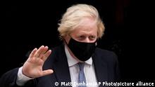 British Prime Minister Boris Johnson waves at the media as he leaves 10 Downing Street to attend the weekly Prime Minister's Questions at the Houses of Parliament, in London, Wednesday, Dec. 8, 2021. (AP Photo/Matt Dunham)
