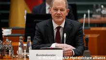 German Chancellor Olaf Scholz speaks as he arrives for the first cabinet meeting of the new German government at the Chancellery in Berlin, Germany, Wednesday, Dec. 8, 2021. (AP Photo/Michael Sohn)
