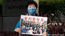 A pro-Beijing protester holds a banner that reads heavy penalty for Jimmy Lai outside the Wanchai district court in Hong Kong on December 9, 2021, where jailed media mogul Jimmy Lai was among three democracy campaigners convicted for taking part in a banned Tiananmen vigil as the prosecution of multiple activists came to a conclusion. (Photo by Bertha WANG / AFP) (Photo by BERTHA WANG/AFP via Getty Images)