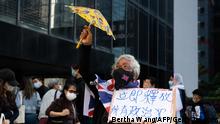 Pro-democracy activist Alexandra Wong, also known as Grandma Wong, gestures outside the Wanchai district court in Hong Kong on December 9, 2021, where jailed media mogul Jimmy Lai was among three democracy campaigners convicted for taking part in a banned Tiananmen vigil as the prosecution of multiple activists came to a conclusion. (Photo by Bertha WANG / AFP) (Photo by BERTHA WANG/AFP via Getty Images)