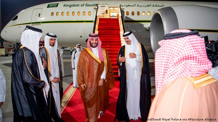 Saudi Crown Prince Mohammed bin Salman, center left, is greeted by Qatar's Emir Sheikh Tamim bin Hamad Al Thani upon his arrival at Doha airport, Qatar, Dec. 8, 2021.