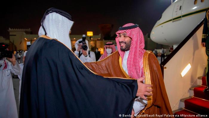 Saudi Crown Prince Mohammed bin Salman, right, is greeted by Qatar's Emir Sheikh Tamim bin Hamad Al Thani upon his arrival at Doha airport in Qatar late Wednesday, Dec. 8, 2021.