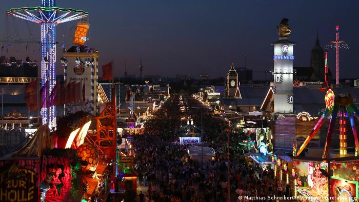 Aerial view of the brightly lit Oktoberfest rides and tents at night, Munich, Germany