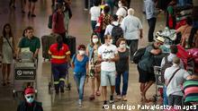 SAO PAULO, BRAZIL - MARCH 14: Passengers walk wearing protective masks at Guarulhos International Airport on March 14, 2020 in Sao Paulo, Brazil. The Government of the State of Sao Paulo issued a list of new guidelines to help prevent the spread of the coronavirus. (COVID-19) According to the Ministry of Health, as of Friday 13th, Brazil had 98 confirmed cases of coronavirus (COVID-19). (Photo by Rodrigo Paiva/Getty Images)