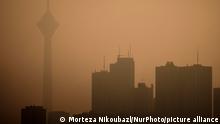 A view of the Milad telecommunication tower (L) and residential complexes in western Tehran during a polluted air, following the COVID-19 outbreak in Iran, on January 12, 2021. Tehran is wedged between mountains and dirty air can get trapped when there is no wind or rain. Iranian health experts say thousands of deaths a year are caused by heart attacks and respiratory illnesses brought on by smog. (Photo by Morteza Nikoubazl/NurPhoto)