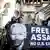 Supporters holds a banner showing Julian Assange with his mouth covered by the US flag  with the words 'free Assange, no US extradition'