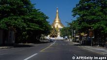 An empty street is pictured near Shwedagon Pagoda, as demonstrators called for a silent strike in protest against the military coup, in Yangon on December 10, 2021. (Photo by AFP) (Photo by STR/AFP via Getty Images)