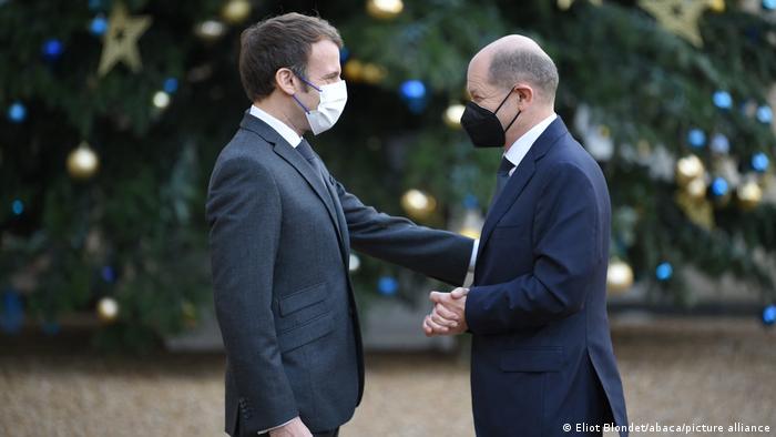 French President Emmanuel Macron greets German Chancellor Olaf Scholz in Paris