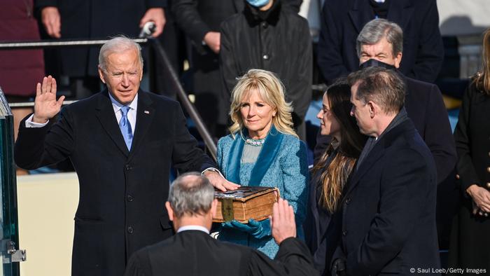 Joe Biden pictured being sworn in as president as his wife Jill Bidne holds the Bible