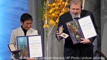 Nobel Peace Prize winners Dmitry Muratov from Russia and Maria Ressa of the Philippines pose with their awards during the Nobel Peace Prize ceremony at Oslo City Hall, Norway, Friday, Dec. 10, 2021. The Norwegian Nobel Committee cited Ressa and Muratov's fight for freedom of expression, stressing that it is vital in promoting peace. (AP Photo/Alexander Zemlianichenko)