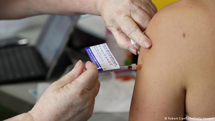 A vaccine being injected in an arm