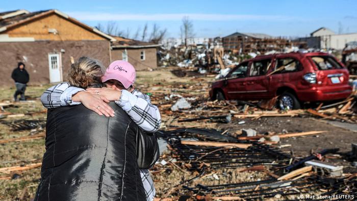 Irene Noltner consoles Jody O'Neill outside The Lighthouse, a women and children's shelter that was destroyed by a tornado along with much of the downtown of Mayfield, Kentucky