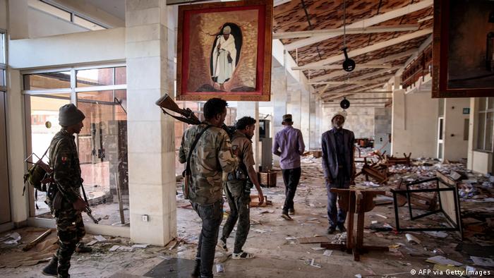 Amhara Fano militia fighters walk in the ransacked terminal at the Lalibela airport in Lalibela, on December 7, 2021