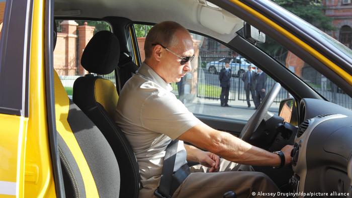 Russian Prime Minister Vladimir Putin drives a car