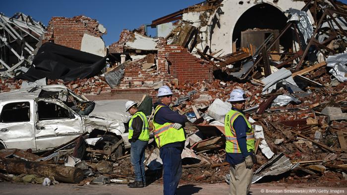 Workers survey tornado damage after extreme weather hit the region December 12, 2021, in Mayfield, Kentucky