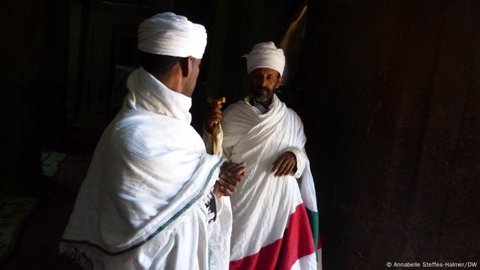 Two priests look at each other