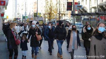 Passers-by in protective masks on the streets of Madrid