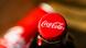 Bottle top of a Coca-Cola with the famous company logo Bottle top of a Coca-Cola with the famous company logo