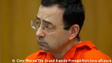 FILE - In this Jan. 31, 2018 file photo, Larry Nassar appears for his sentencing at Eaton County Circuit Court in Charlotte, Mich. The Justice Department's inspector general is investigating how the FBI handled sexual abuse allegations against the former USA Gymnastics national team doctor, a person familiar with the matter said Wednesday, Sept. 5 The investigation comes amid allegations that the FBI had failed to promptly address complaints made in 2015 against Nasser, a once-renowned gymnastics doctor. Nassar is now serving decades in prison after hundreds of girls and women said he sexually abused them under the guise of medical treatment when he worked for Michigan State and Indiana-based USA Gymnastics, which trains Olympians. (Cory Morse /The Grand Rapids Press via AP, File)