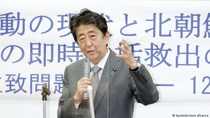 Shinzo Abe speaking with a microphone