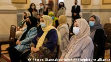 Afghan women attend a meeting with Greek President Katerina Sakellaropoulou, at the Presidential Palace, in Athens, on Tuesday, Oct. 12, 2021. The Afghan women, part of a group of judges, lawyers and lawmakers who fled Afghanistan following the Taliban takeover, meet with Greek President before they reach their final destination in the United States. (AP Photo/Petros Giannakouris) 