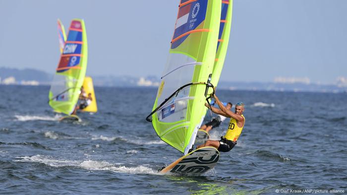 Wind surfers glide across the sea