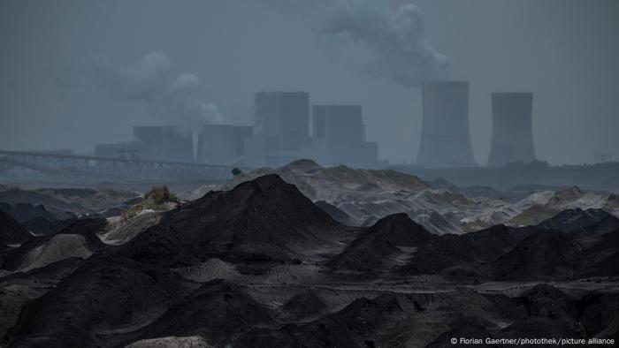 Dark image of the Boxberg coal-fired power plant with towers emitting smoke and steam