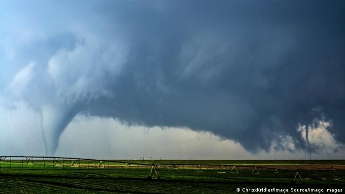 A supercell thunderstorm produces two tornadoes in a farm field in Kansas in the United States
