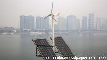 ©/MAXPPP - XIANGYANG, CHINA - JANUARY 04: A hybrid power facility combining wind turbine and solar panels stands on the banks of Han River on January 4, 2021 in Xiangyang, Hubei Province of China. (Photo by Li Fuhua/VCG)