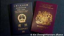 FILE - In this Jan. 29, 2021, file photo, a British National Overseas passports (BNO) and a Hong Kong Special Administrative Region of the People's Republic of China passport are pictured in Hong Kong. Hong Kong’s government says it will ban all passenger flights from the U.K. starting Thursday, July 1, 2021, as it seeks to curb the spread of new variants of the coronavirus. The ban comes amid heightened tensions between the U.K. and China over semi-autonomous Hong Kong, which was a British colony until it was handed over to China in 1997. (AP Photo/Kin Cheung, File)