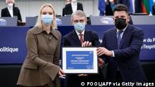 The Daughter of Russian opposition leader Alexei Navalny, Daria Navalnaya (L), poses after receiving the Sakharov prize on his behalf, with European Parliament President David Sassoli (C) and the Chief of Staff of Alexei Navalny, Leonid Volkov(R) during the Award ceremony of the Sakharov Prize at the European Parliament in Strasbourg on December 15, 2021. (Photo by Julien WARNAND / POOL / AFP) (Photo by JULIEN WARNAND/POOL/AFP via Getty Images)