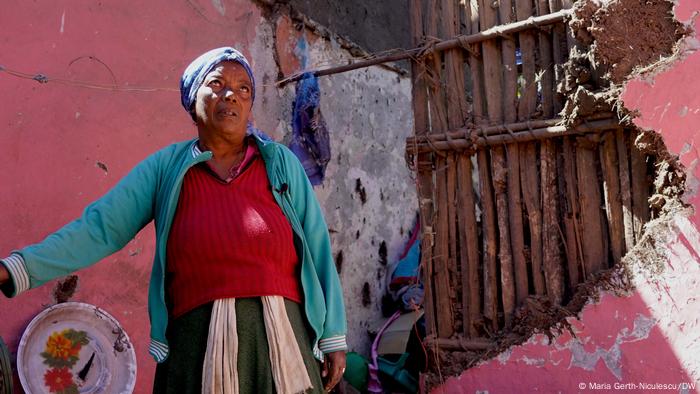 Ayu Berhan in the ruins of her house