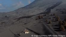 TOPSHOT - This aerial picture shows a house covered with lava and ashes following the eruption of the Cumbre Vieja volcano, in Las Manchas, on the Canary Island of La Palma on December 14, 2021. - The Cumbre Vieja volcano has been erupting since September 19, forcing more than 6,000 people out of their homes as the lava burnt its way across huge swathes of land on the western side of La Palma. (Photo by JORGE GUERRERO / AFP) (Photo by JORGE GUERRERO/AFP via Getty Images)