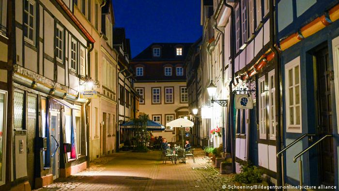 Little alleyway with cafes at night in the old town center of Hameln, Germany