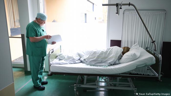 A woman lying in a bed in a hospital after undergoing an abortion procedure in Prenzlau, Germany