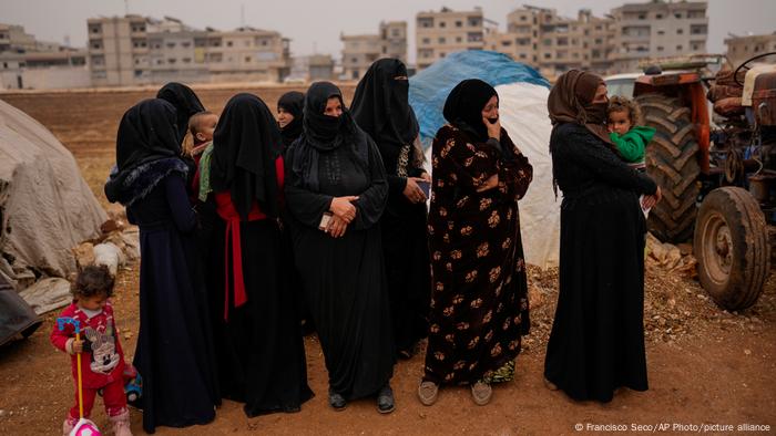 Women queue for food.