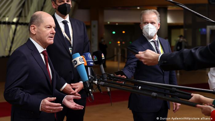 German Chancellor Olaf Scholz (left) makes a press statement in Brussels