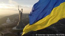 Ukraine's biggest national flag on the country's highest flagpole and the giant 'Motherland' monument are seen at a compound of the World War II museum in Kyiv, Ukraine, December 16, 2021. Picture taken with a drone. REUTERS/Valentyn Ogirenko 